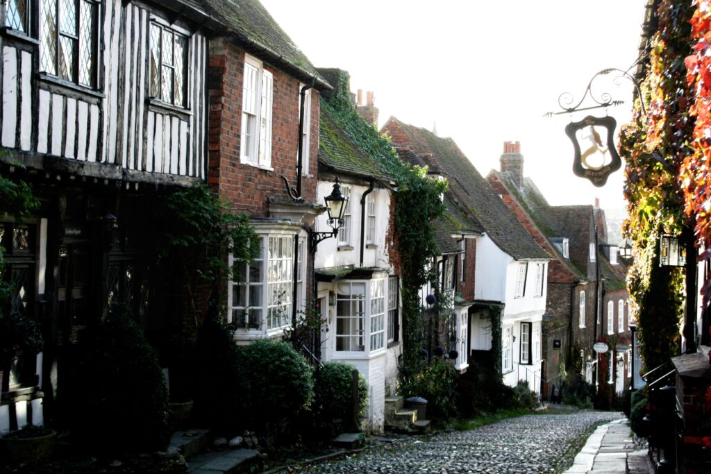 A cobblestone street lined with old buildings A cobblestone street lined with old buildings