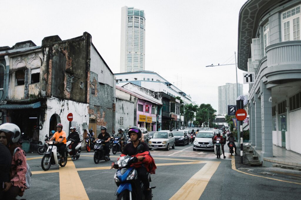 A group of people riding motorcycles down a street A group of people riding motorcycles down a street