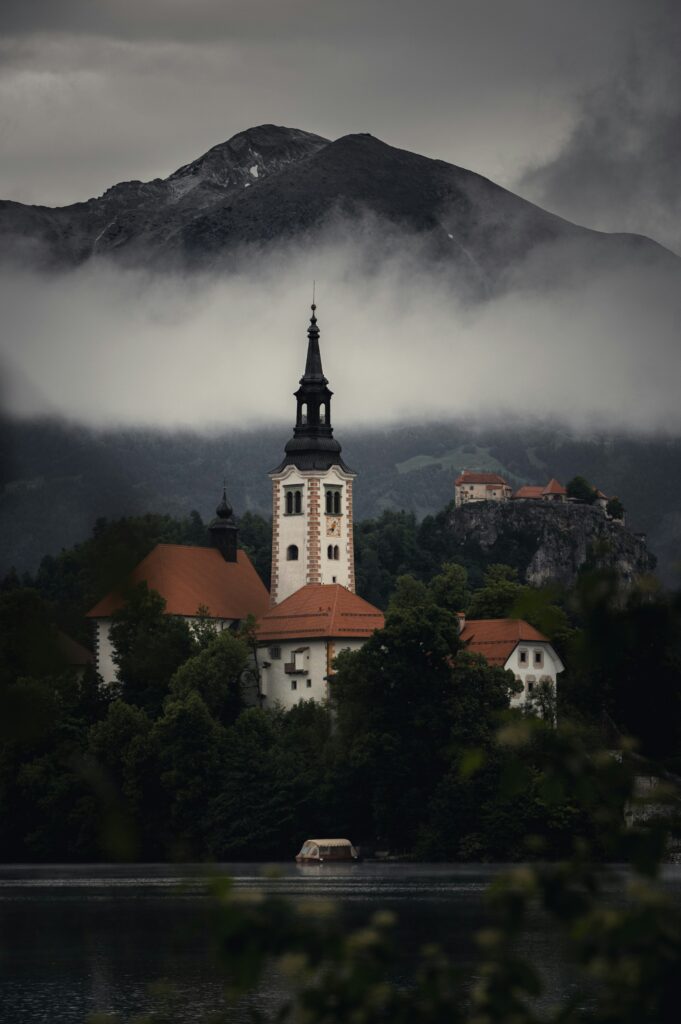a building with a tower and a mountain in the background a building with a tower and a mountain in the background