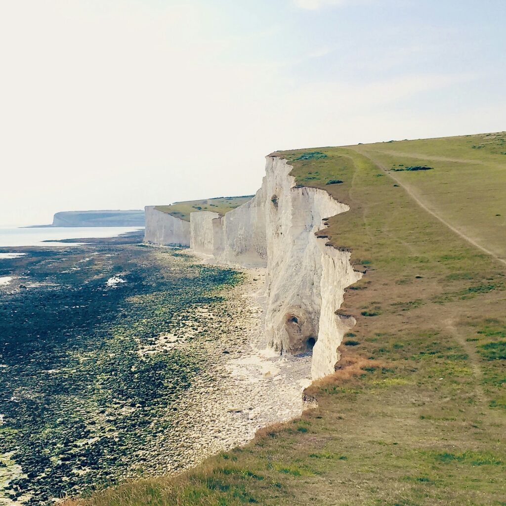 a cliff side with a waterfall a cliff side with a waterfall
