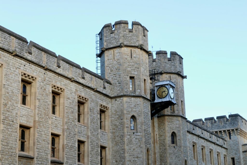 a clock on the side of a stone building a clock on the side of a stone building