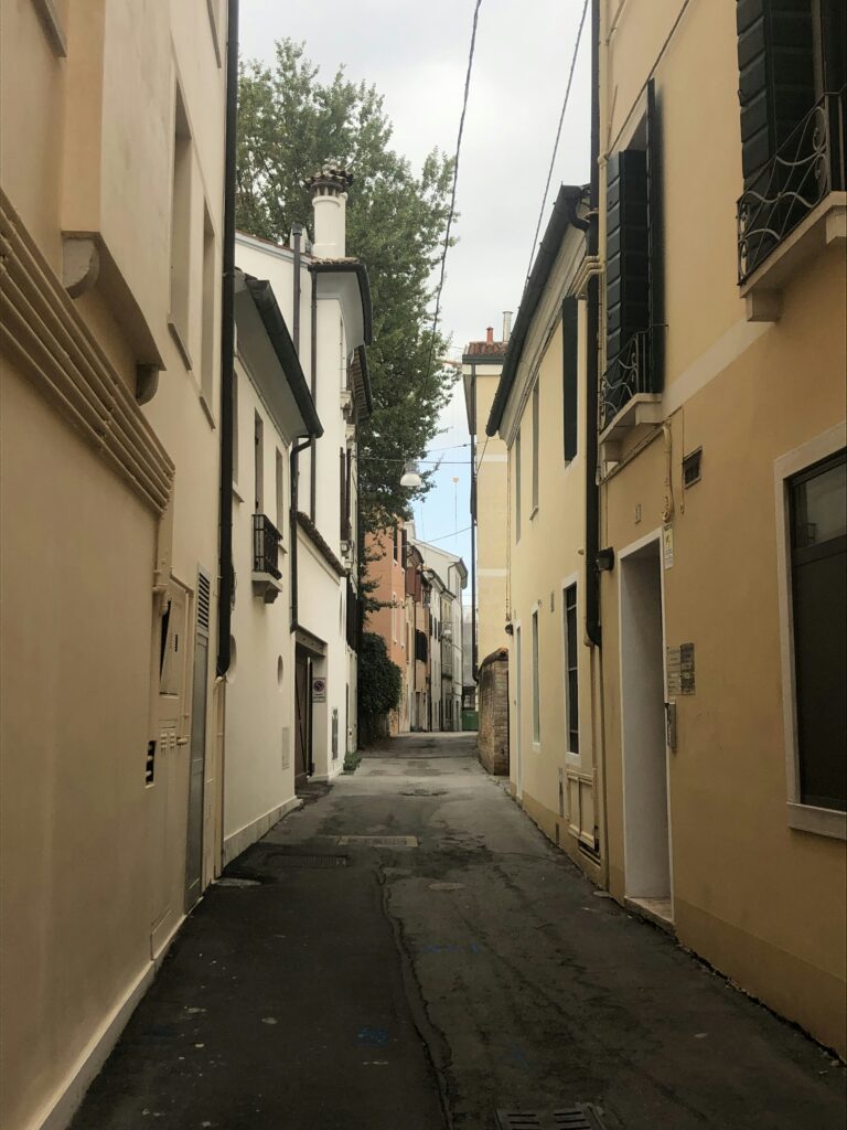 a narrow city street with buildings on both sides a narrow city street with buildings on both sides