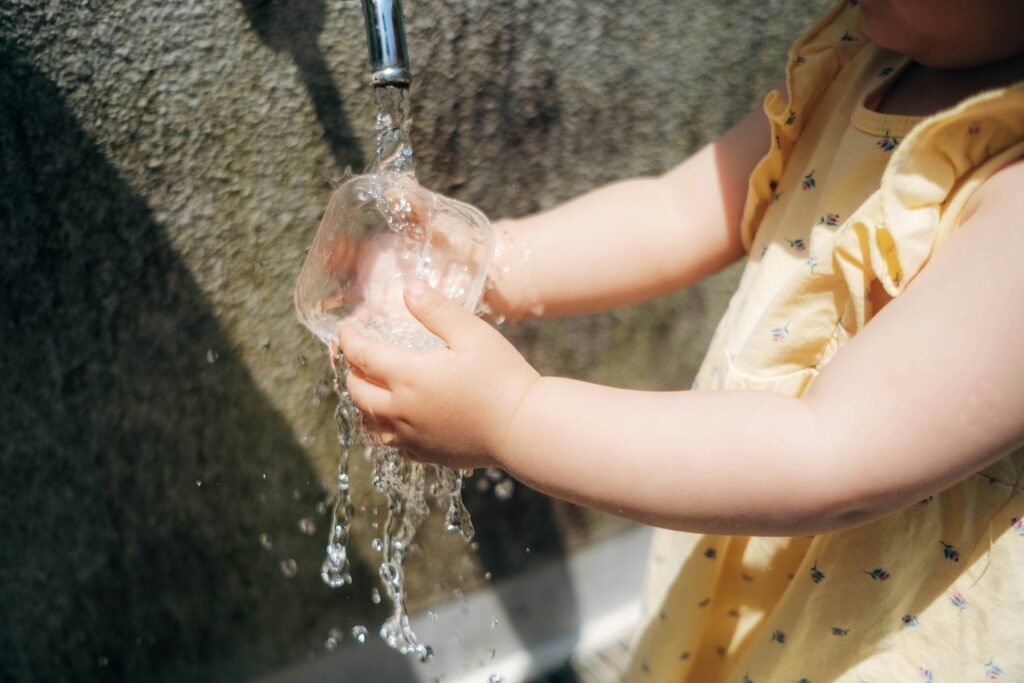a person pouring water into a sink a person pouring water into a sink