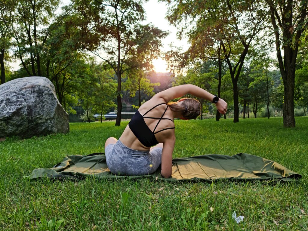 a woman is doing yoga in a park a woman is doing yoga in a park