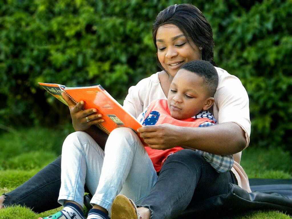 a woman reading a book to a child a woman reading a book to a child