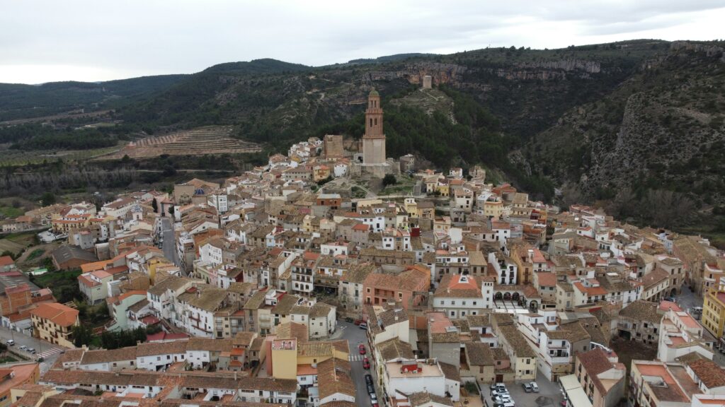 an aerial view of a village in the mountains an aerial view of a village in the mountains
